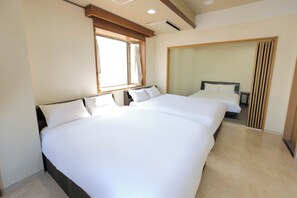 A hotel room with two beds, a large window, and a mirror. - Sweetpad (Setagaya City)