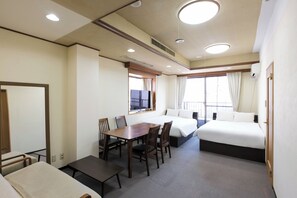 A hotel room with a bed, a desk, and chairs. - Sweetpad (Setagaya City)