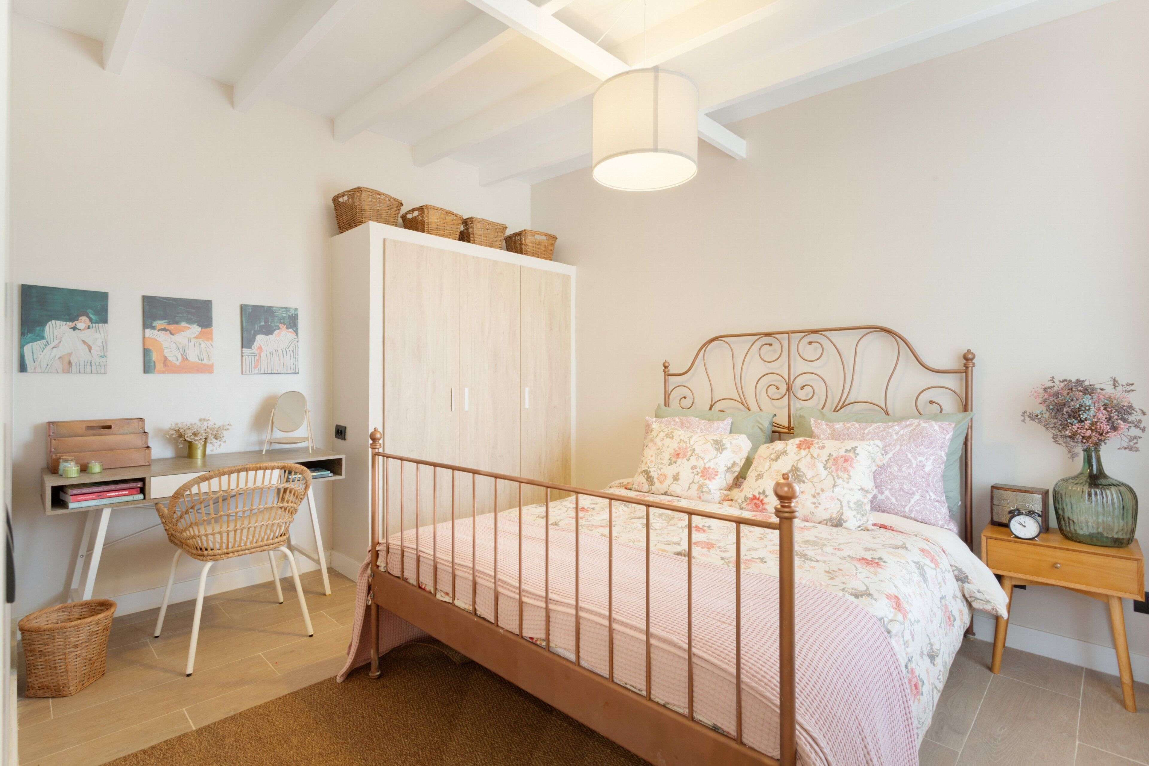 A bedroom with a bed, a desk, a chair, and a wardrobe.