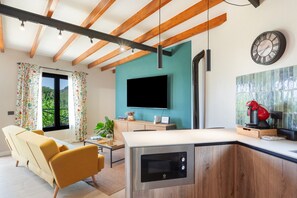 A modern kitchen with a built-in microwave, a wooden ceiling, and a large window. -  'El Llano' with Sea View, Private Pool and Wi-Fi (La Orotava)