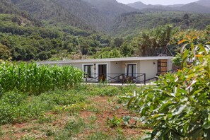 A modern building with a flat roof, large windows, and a balcony. -  'El Llano' with Sea View, Private Pool and Wi-Fi (La Orotava)