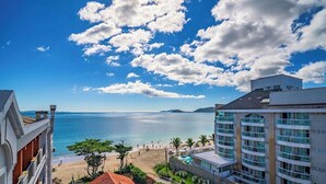 A coastal hotel with a beach view, multiple balconies, and a pool area. - Apt. w/ Balcony 90m From the Beach Lpa0504 (Florianópolis)