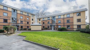 A multi-story residential building with a central courtyard, brick facade, and a flat roof. - Student Only Clarence Dock (Leeds)