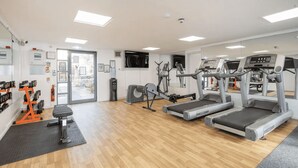 A gym with treadmills, a stationary bike, and weight machines. - Student Only Clarence Dock (Leeds)