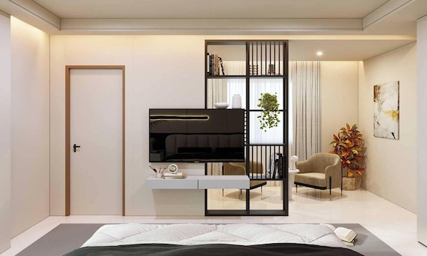 A modern bedroom with a bed, a TV, a bookshelf, and a chair.