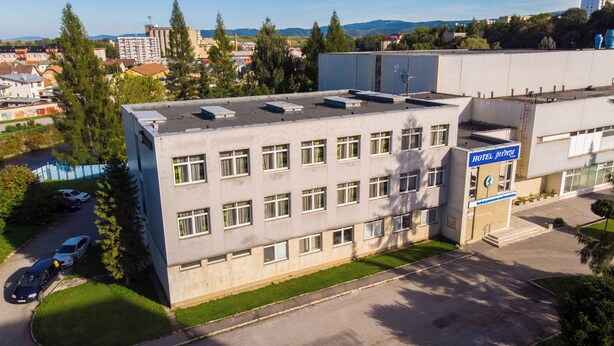 A hotel building with multiple windows, a flat roof, and a sign indicating it is a hotel. - Hotel Preveza (Spišská Nová Ves)