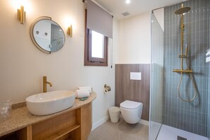 A modern bathroom with a large oval sink, a toilet, and a glass-enclosed shower area. - Standard double Mercado apartment with jacuzzi (Alicante)