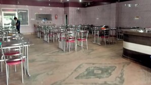 A conference room with rows of chairs and a podium. - Hotel Shakti (Cuttack)