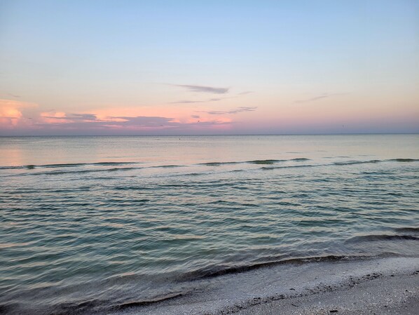 A beach with gentle waves and a clear sky. - Oceanside Marco Island Retreat: Expansive Views of Sunset, Pool & Beach (Marco Island)