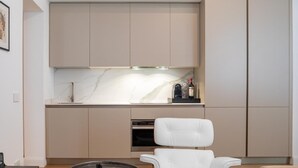 A modern kitchen with a marble countertop, a built-in oven, and a wine bottle on the counter. - Pool View Suite 205, 50 m² with Bathtub, Breakfast Included (Fucecchio)