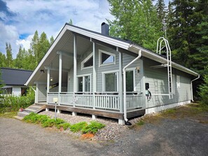 A two-story house with a porch, a chimney, and a number '95' on the side.
