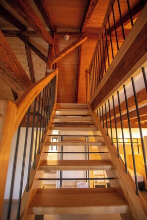 A wooden staircase with metal railings leading to an upper level. - Alter Hafen Marktsteft (Marktsteft)
