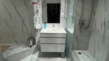 Shower, hair dryer, towels, toilet paper