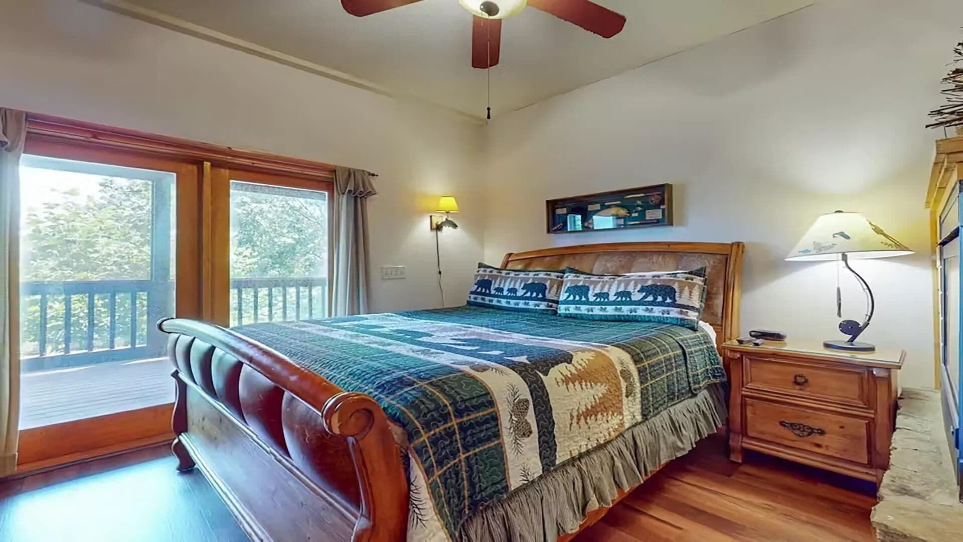 A bedroom with a wooden bed, a nightstand, a lamp, a wall-mounted shelf with items, and a window with curtains.