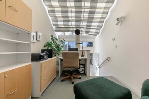 A compact room with a desk, chair, and shelving units. - Spike's Place at Tahoe Donner by Tahoe Getaways - 2BR w 2 Bonus Rooms & Walking Distance to HOA! (Truckee)