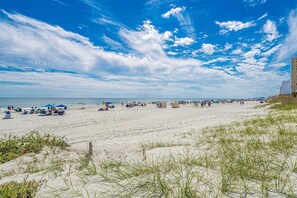 A beach with sand, grass, and a clear sky. - Hang Ten House 2.5 Blocks to Beach Pet Friendly (Myrtle Beach)