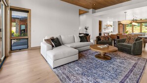 A spacious living area with a white sectional sofa, a round coffee table, and two armchairs. - Clubhouse Close Villa, golf, min 90 day stay (Heber City)