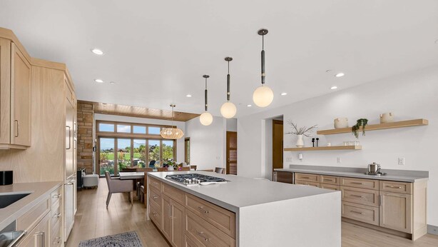 A modern kitchen with a central island, wooden cabinets, and pendant lighting. - Clubhouse Close Villa, golf, min 90 day stay (Heber City)