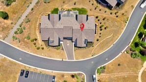 An aerial view of a residential area with a central building surrounded by parking spaces and a curved road. - Clubhouse Close Villa, golf, min 90 day stay (Heber City)