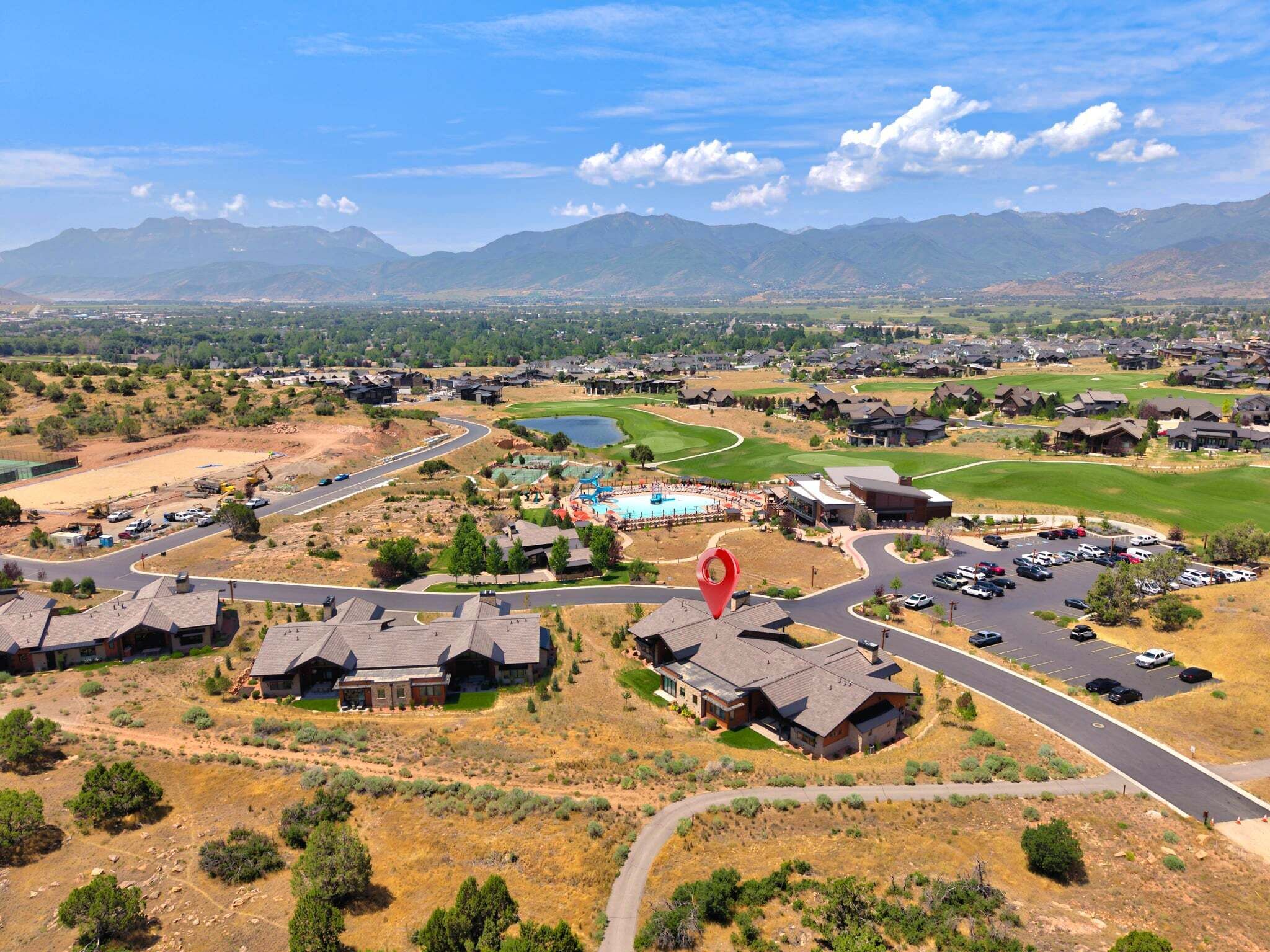 A residential area with houses, roads, and a golf course.