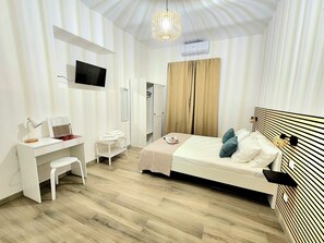 A hotel room with a bed, a desk, a chair, a TV, and a wardrobe. - Teo's House: Just a Stone's Throw from the Metro (Roma)