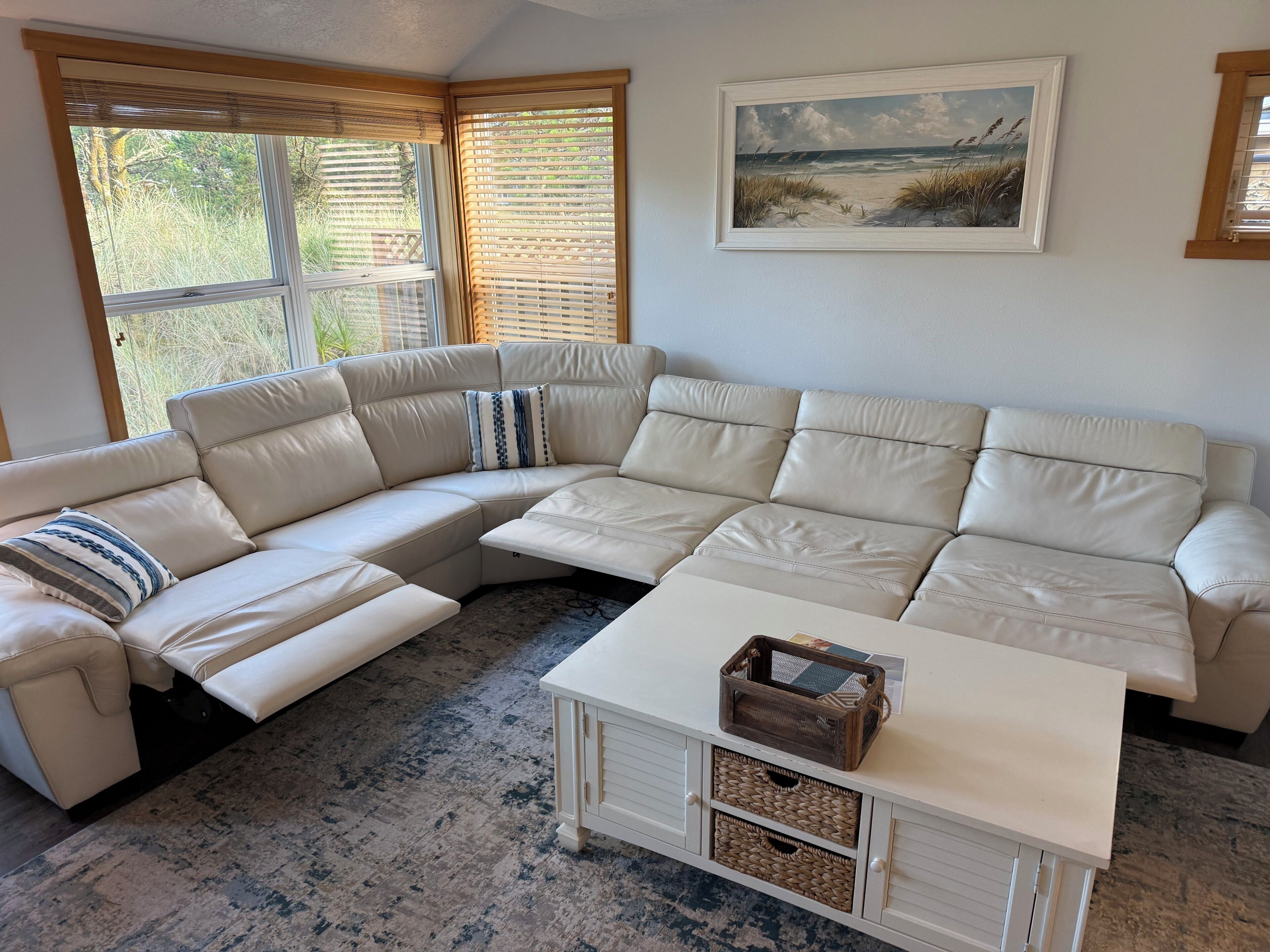 A sectional sofa with storage drawers and a coffee table with baskets.