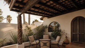 An outdoor patio with a pergola, seating area, and a view of the surrounding landscape. - Authentic Beachfront Home | Panoramic Ocean Views (Puerto Peñasco)