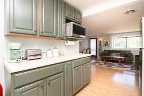 A kitchen with a microwave, toaster, and coffee maker on the counter. - Beach Block 3BR Home - Walk to Beach, Dining & Bars (Dewey Beach)