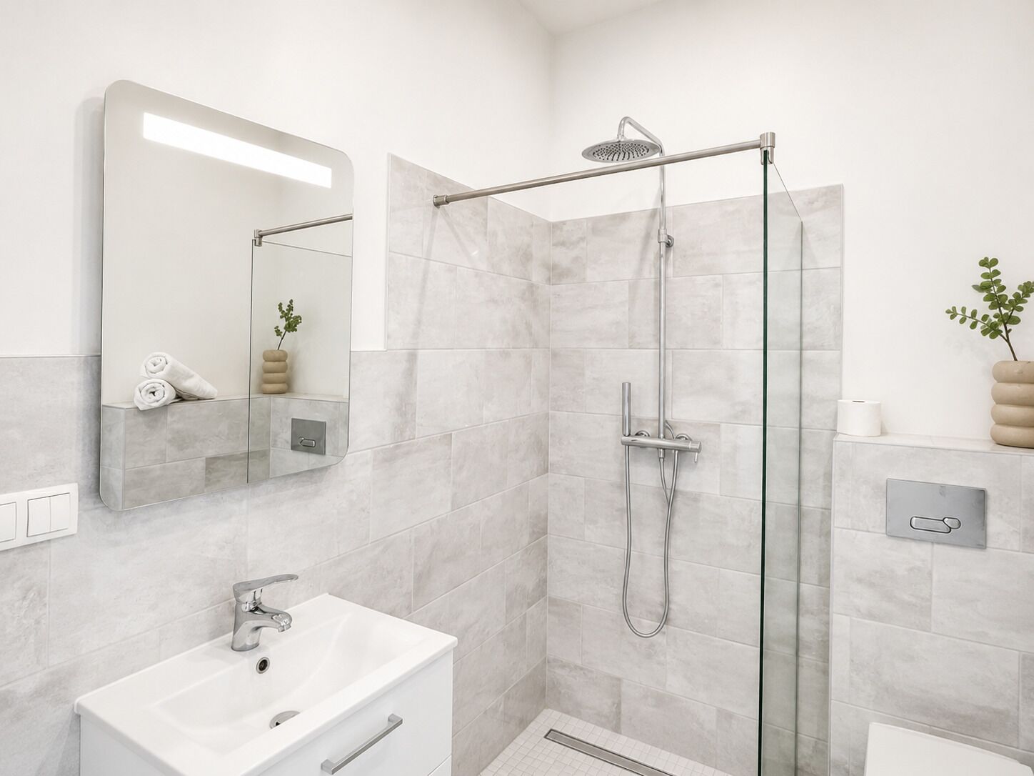 Modern private bathroom with a spacious walk-in rain shower.