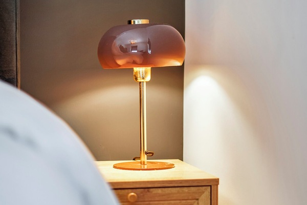 Warm bedside lighting creates a cozy ambiance, perfect for relaxing after exploring the village center.