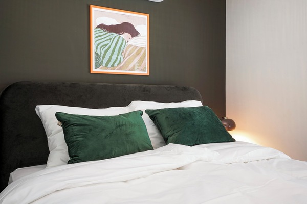 Spacious king bedroom featuring quality bedding and air conditioning for year-round comfort during your stay.