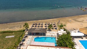 A resort with a swimming pool, beach area, and ocean view. - Bed and Breakfast 'The Kavos Sandy Inn-Double Room' with Shared Pool, Wi-Fi and Air Conditioning (Kavos)