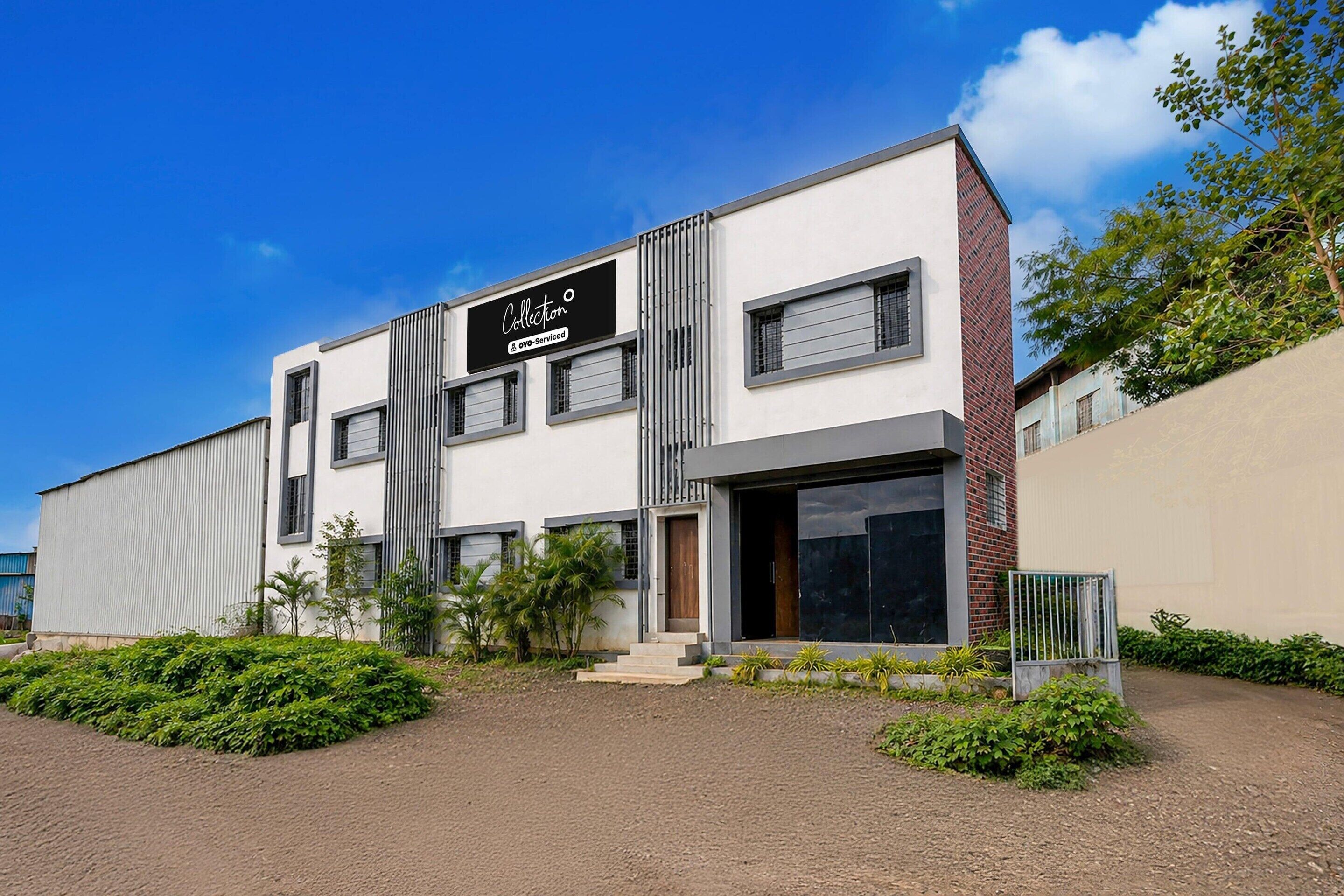 A modern building with a sign that reads 'Collection OYO-Serviced.'