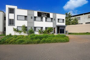 A modern building with a sign that reads 'Collection OYO-Serviced.' - Deluxe Room KP Pride (Pune)
