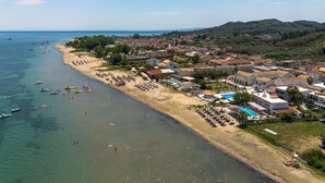An aerial view of a coastal town with a beach, boats, and a variety of buildings. - Bed and Breakfast 'The Kavos Sandy Inn-Double Room' with Shared Pool, Wi-Fi and Air Conditioning (Kavos)