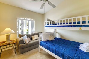 A room with a bunk bed, a sofa, a lamp, and a window with blinds. - Near Disney & Top Attractions! Poolside Oasis (Davenport)