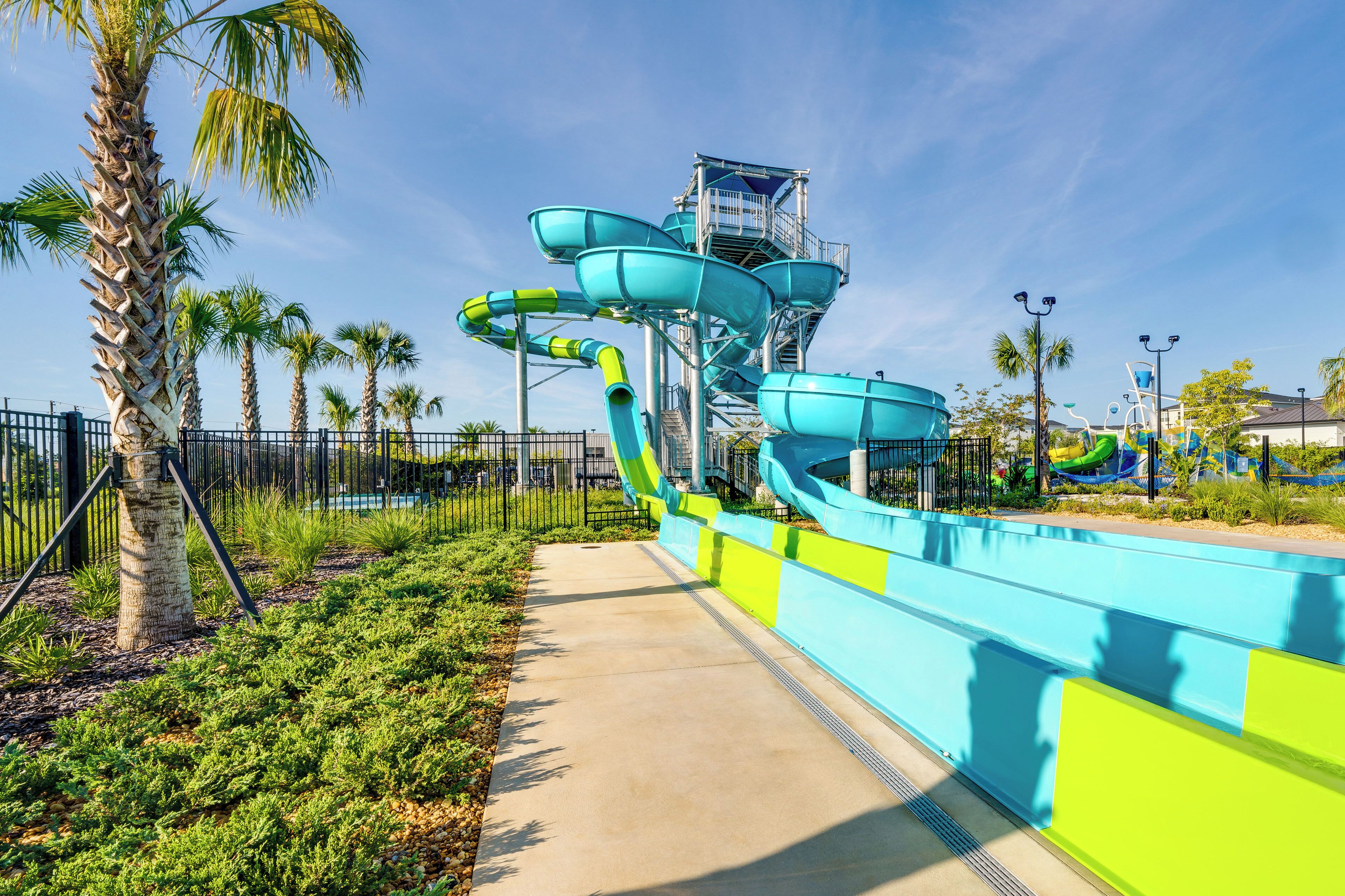 A water park with multiple slides and a clear sky.