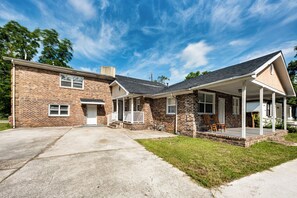 A two-story brick house with a front porch, a garage, and a well-maintained lawn. - 9 Mi to Dtwn Charleston! Park Circle Extended Stay (North Charleston)