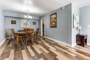 A dining room with a wooden table and chairs, a chandelier, and artwork on the walls. - 9 Mi to Dtwn Charleston! Park Circle Extended Stay (North Charleston)