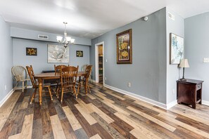 A dining room with a wooden table and chairs, a chandelier, and artwork on the walls. - 9 Mi to Dtwn Charleston! Park Circle Extended Stay (North Charleston)