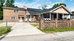 A two-story brick house with a front porch, a garage, and a driveway. - 9 Mi to Dtwn Charleston! Park Circle Extended Stay (North Charleston)