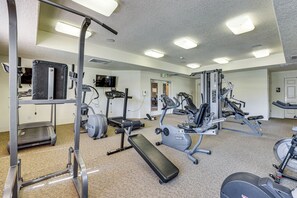 Ein Fitnessstudio mit unterschiedlichen Trainingsgeräten, darunter Laufbänder, Ergometer und Kraftgeräte.