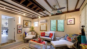 A cozy living room with a sofa, armchairs, a coffee table, and a ceiling fan. - Pool, Putting Green Access! Backyard Retreat (Thomaston)