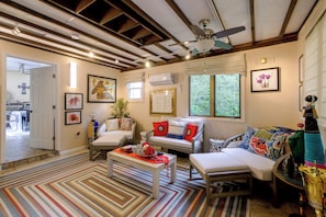 A cozy living room with a sofa, armchairs, a coffee table, and a ceiling fan. - Pool, Putting Green Access! Backyard Retreat (Thomaston)