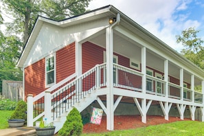 A two-story house with a covered porch and a staircase leading to the second floor. - Walk to Waynesville Hot Spots! 'woodland Cottage' (Waynesville)