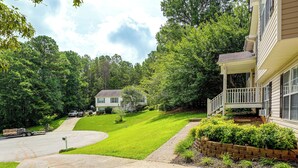 A residential area with a house, a driveway, and a well-maintained lawn.