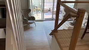 A wooden staircase leading to a room with a view of the outdoors. - Available 9/10 - 5/31/27 Coastal living, steps from the beach, 3-bedroom, (Sea Bright)