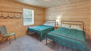 A room with two beds, a chair, a window, and a lamp. - Maine Lodge Base Camp for Hiking, Riding & Fishing (Wesley)