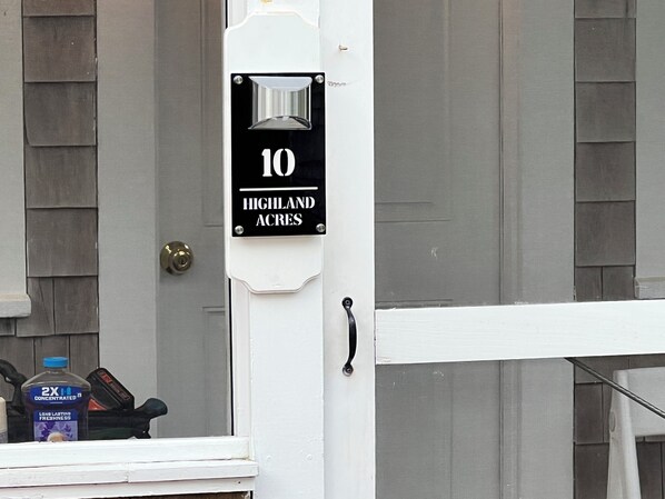 A door with a sign indicating '10 Highland Acres.'