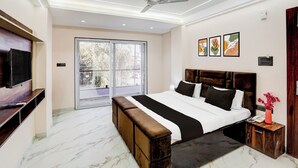 Een moderne slaapkamer met een groot bed, een televisie en een balkon.